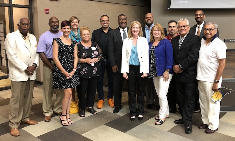 Fort Wayne business leaders, sponsors, and community members pose with Sheridan during his visit.