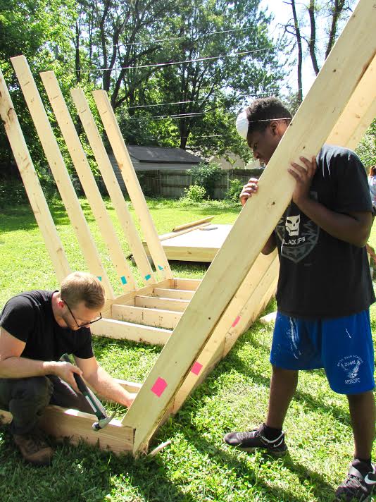 Counselors Sam McCullough and Jesse Hartman construct the campers’ clubhouse design. 