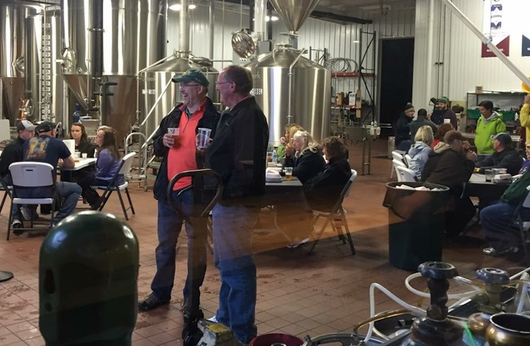Neighbors in Angola gather at the original Chapman's production facility and tap room.