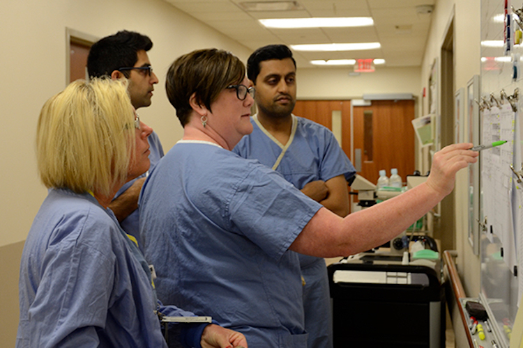 Gupta, left back, learns from the team at Parkview Physicians Group –­ Oncology.