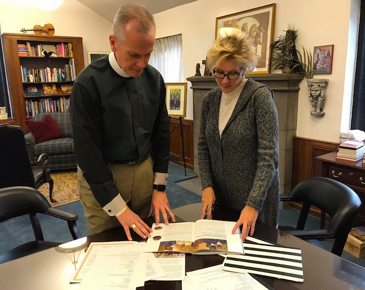 Erdos, left, and Karcher, right, review the church's magazine "Thinking Out Loud."