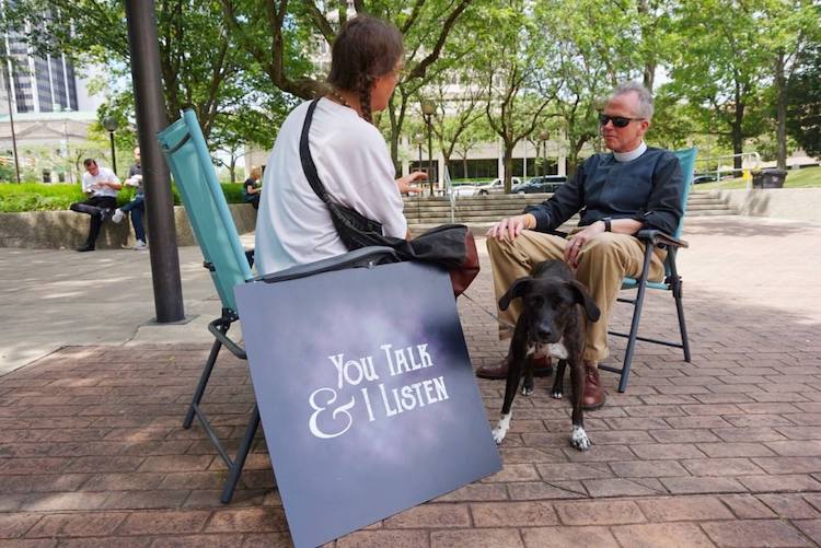 Pastor Gary Erdos, right, listens to citizens at Lunch on the Plaza.