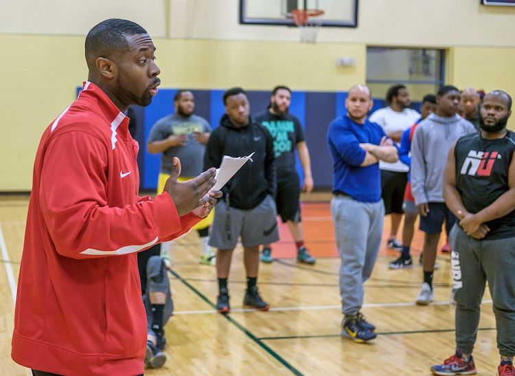 Executive Director of Renaissance Pointe YMCA Amos Norman talks to participants of the Fort Wayne United Late Night Basketball Program.