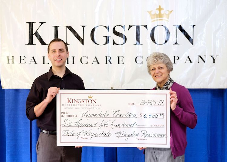 Cornwell, left, and Garrison, right, hold a check from Taste of Waynedale.