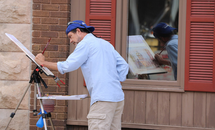 A Plein Air artist paints live on Decatur's streets.