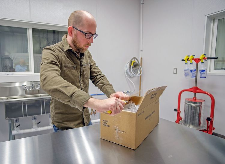 Robert Johnson unpacks a box of frozen blackberries from Tanglewood Berry Farm.