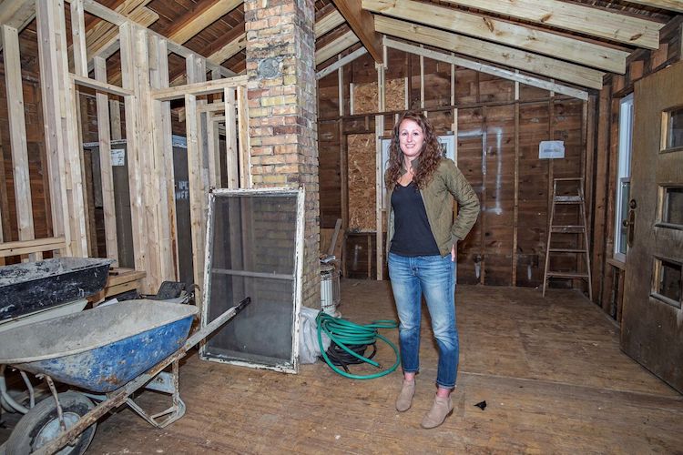 Todd stands in what will be her future tiny house.