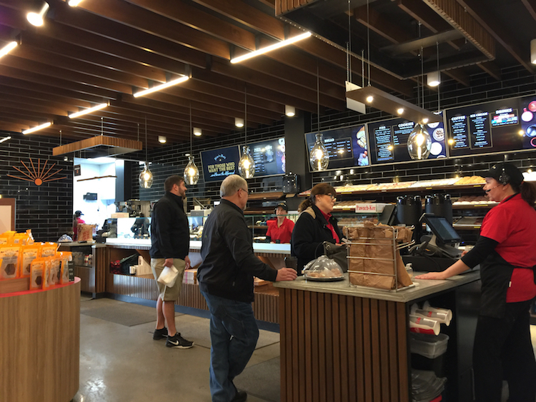 Attendants use headsets to serve guests at Rise ‘n Roll Bakery.