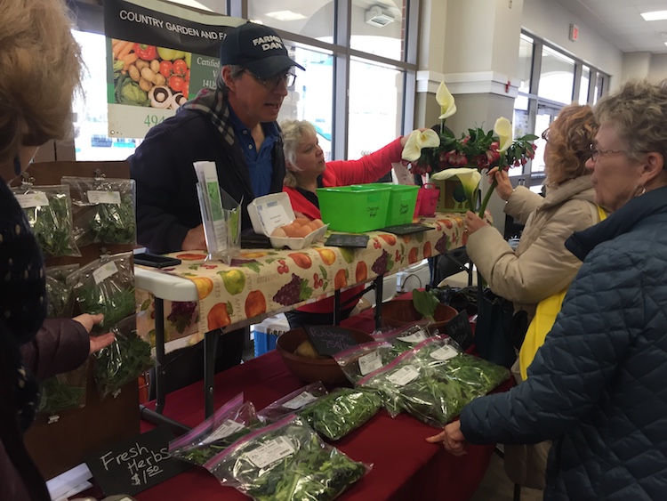 Farmers interact with consumers at the Fort Wayne Farmers Market at Parkview Field.