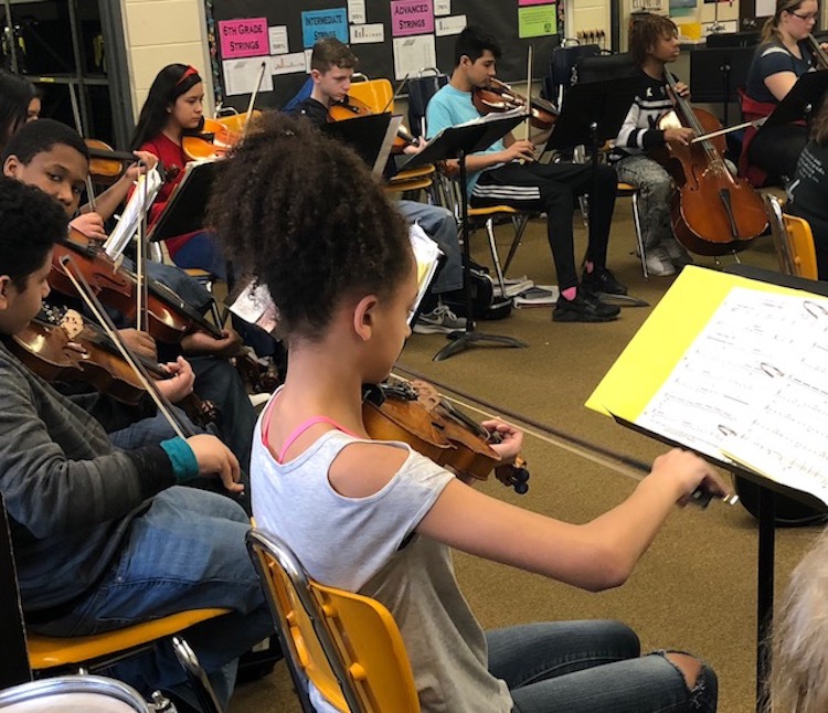 The orchestra class at Lane Middle School, conducted by Miss P, Colleen Phillips.