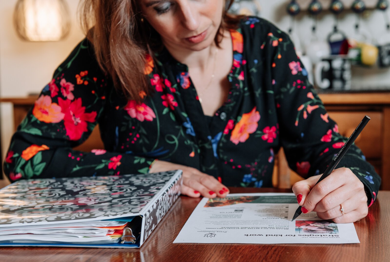 Irene Paxia, President of Petra Solutions, works on marketing materials.