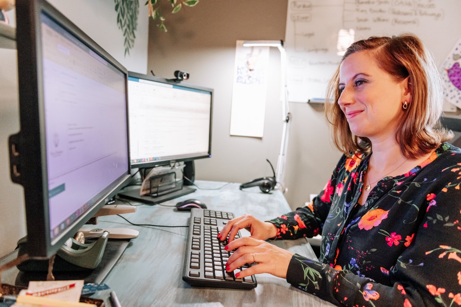 Irene Paxia, President of Petra Solutions, works at her desk.