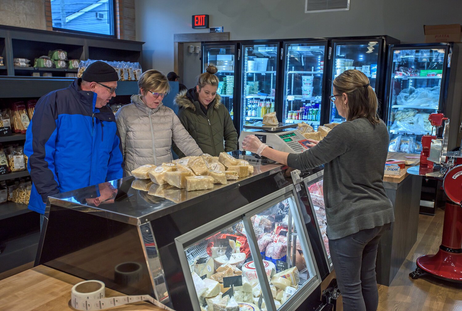 Customers at Antonuccio's Italian Market select meat and cheese at the deli.