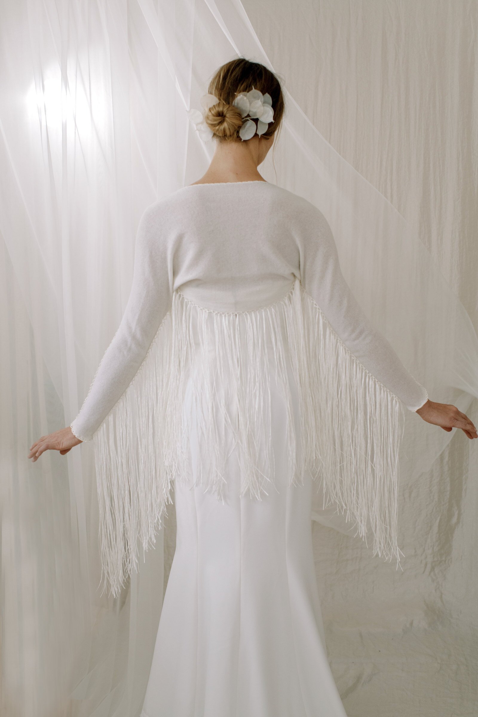 A fringe knit cardigan lends a bohemian feel to weddings.