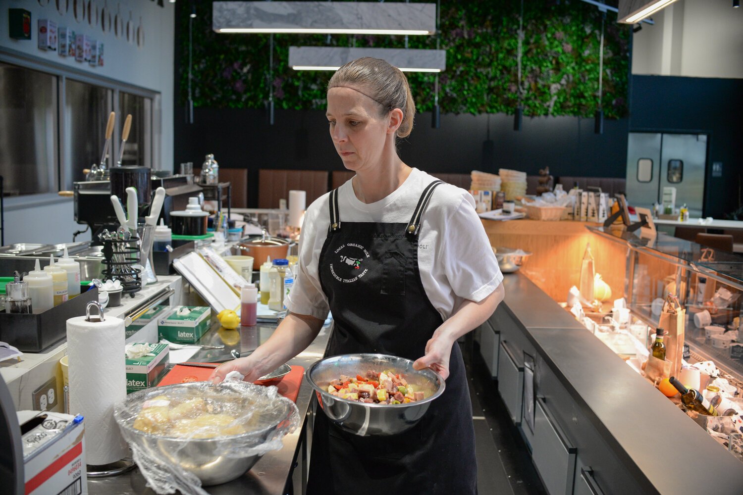 Kim Chaney works on preparing an Antipasto Salad at the Golfo Di Napoli Dairy Caffè.