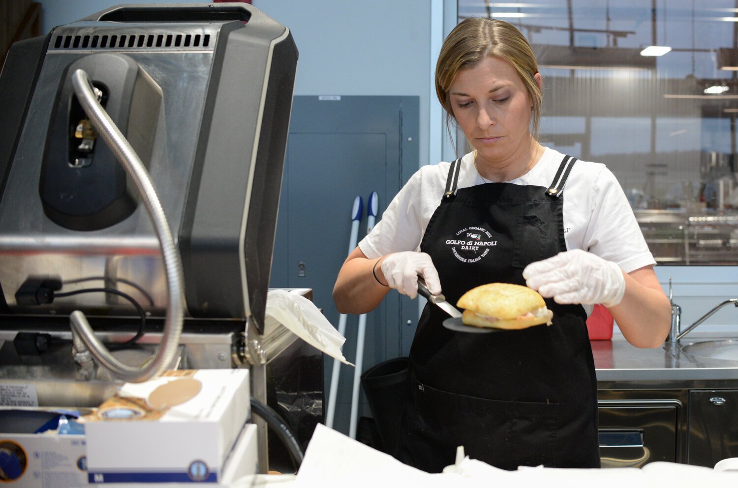 Morgan Zanzinger works on making a Zingara Sandwich out of Ciabatta bread.