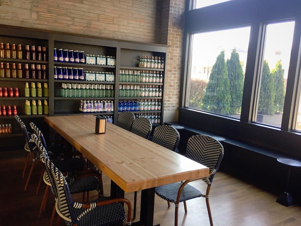 In addition to grocery items, the market will have places to sit and enjoy wine, charcuterie boards, and paninis.