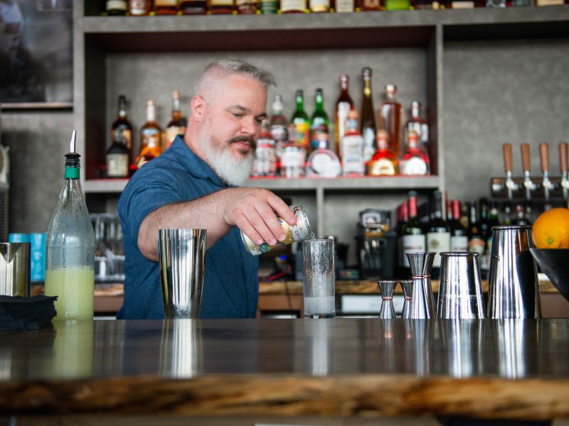 A bartender handcrafts a cocktail at Conner's Rooftop.