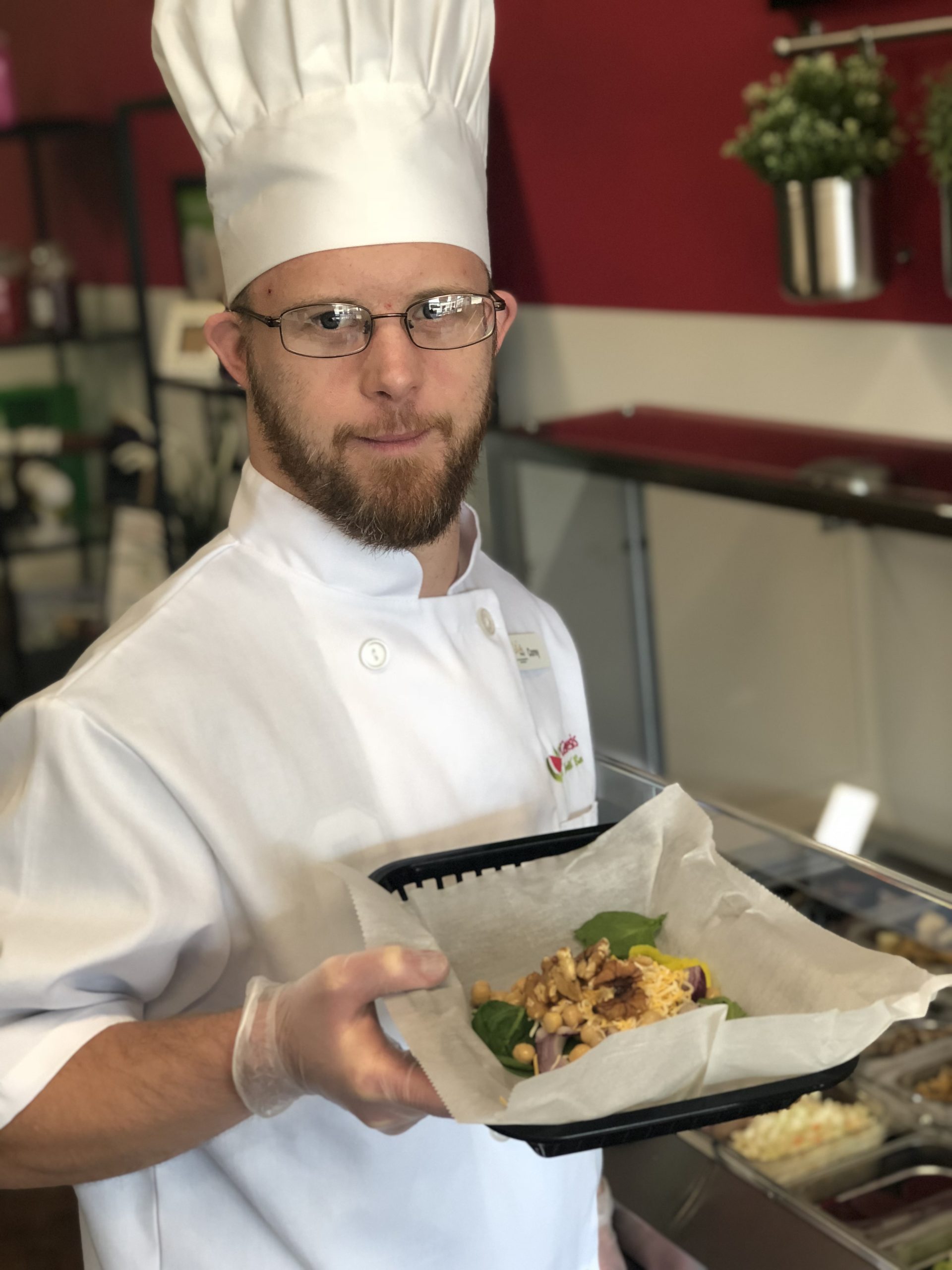Corey has fun stocking the gluten free salad bar.