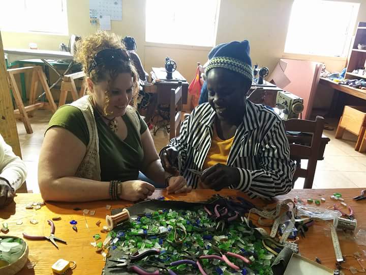 CWOW's Vanessa Sheckler, left, assists a Haitian artist with product development.