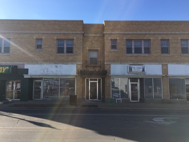 The commercial building was created for mixed-use development with storefronts on the main level and apartments above.