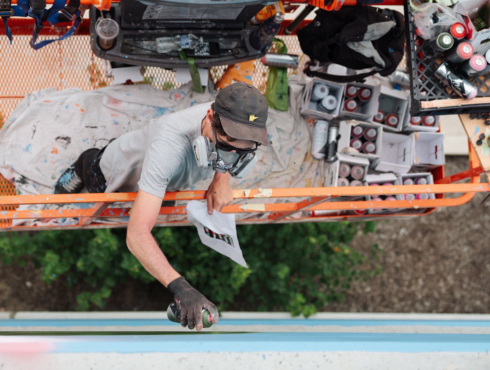 Muralist Damien Mitchell works on his 15,000 square foot mural on the Union Parking Garage at Electric Works.