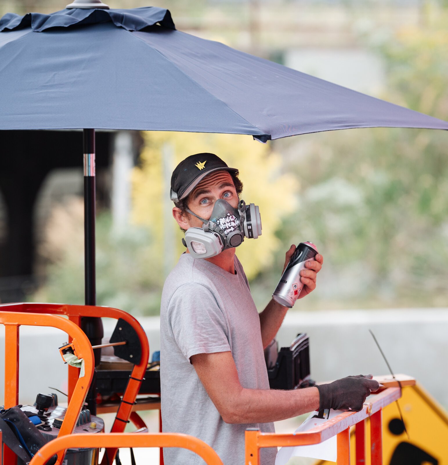 Muralist Damien Mitchell works on his 15,000 square foot mural on the Union Parking Garage at Electric Works.