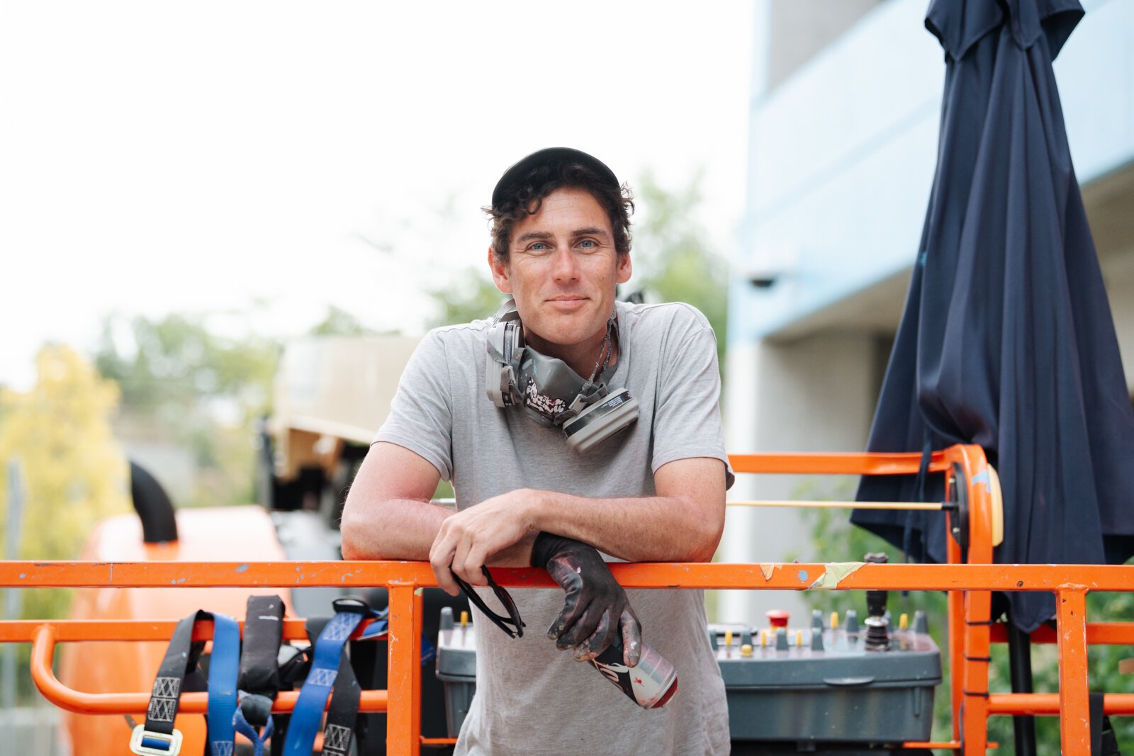 Muralist Damien Mitchell in front of his 15,000 square foot mural on the Union Parking Garage at Electric Works on September 9, 2025.