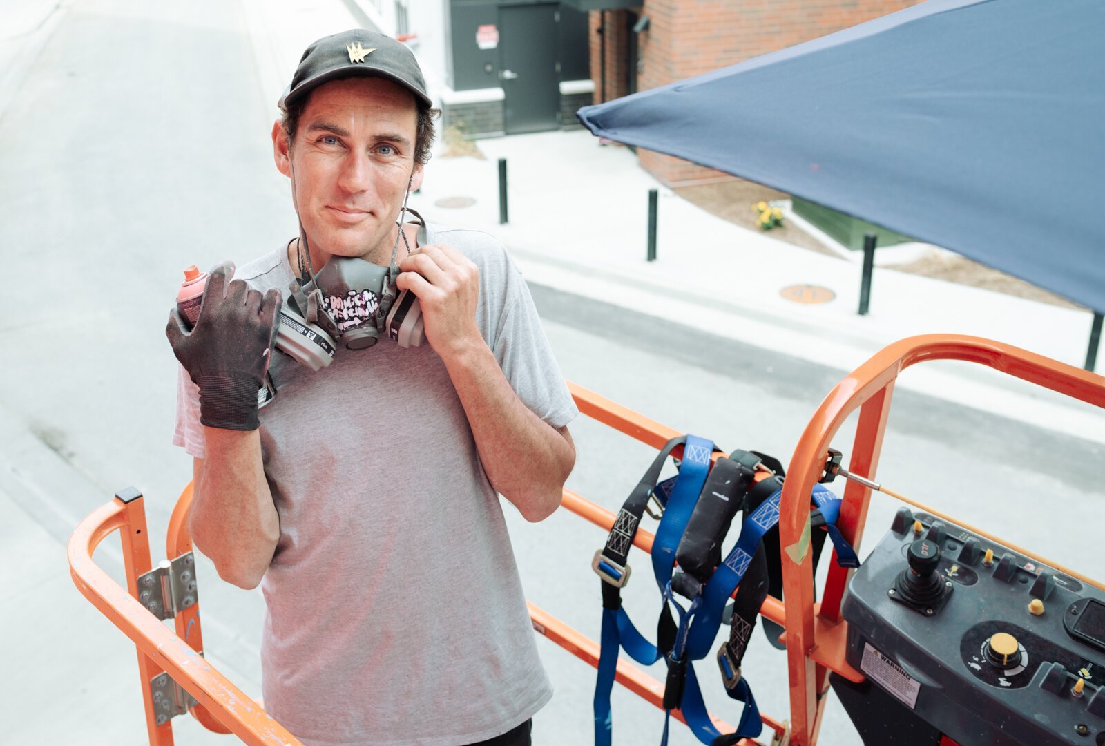Muralist Damien Mitchell in front of his 15,000 square foot mural on the Union Parking Garage at Electric Works on September 9, 2025.
