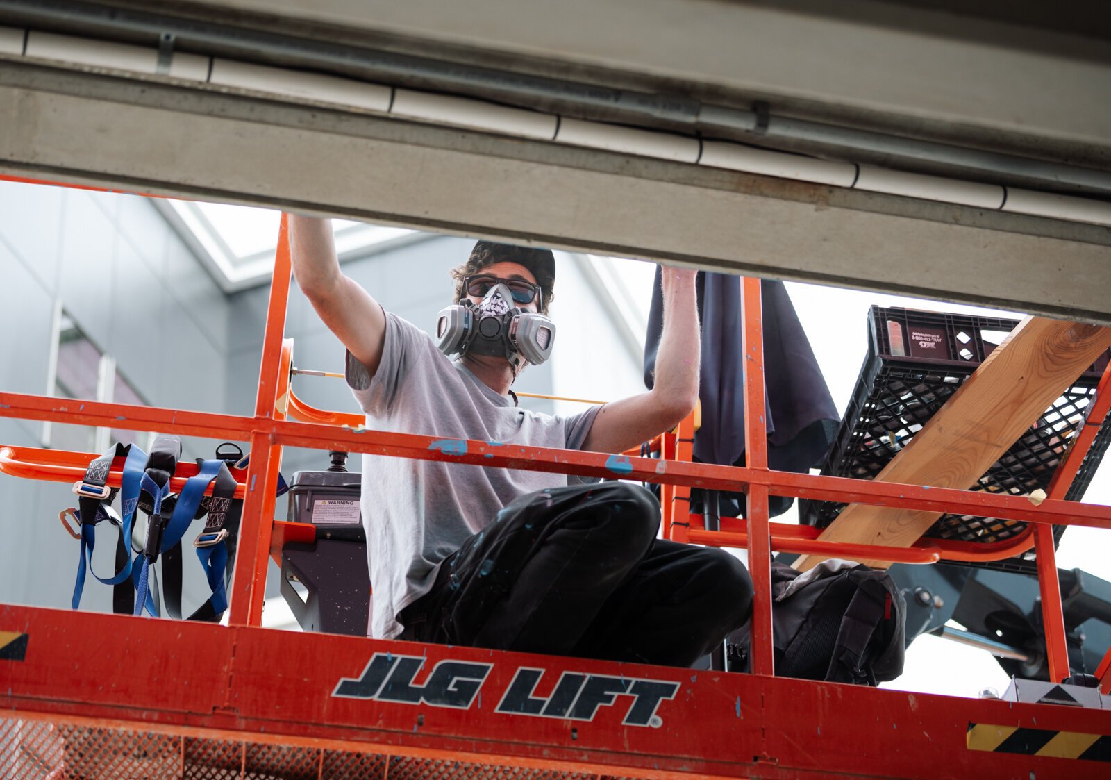 Muralist Damien Mitchell works on his 15,000 square foot mural on the Union Parking Garage at Electric Works.