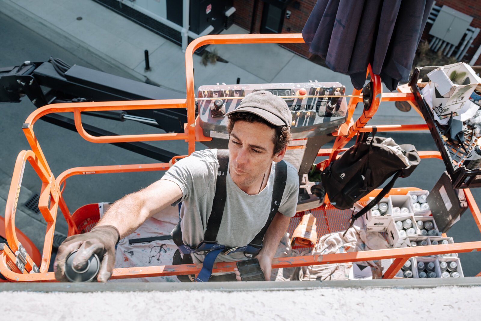 Muralist Damien Mitchell works on his 15,000 square foot mural on the Union Parking Garage at Electric Works on September 12, 2025.