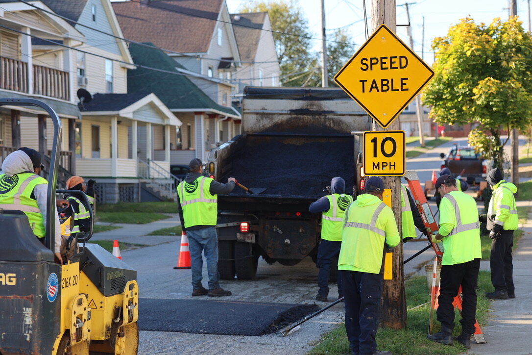 Crews work to install a speed table in Cleveland as part of a growing effort to reduce pedestrian injuries and fatalities.