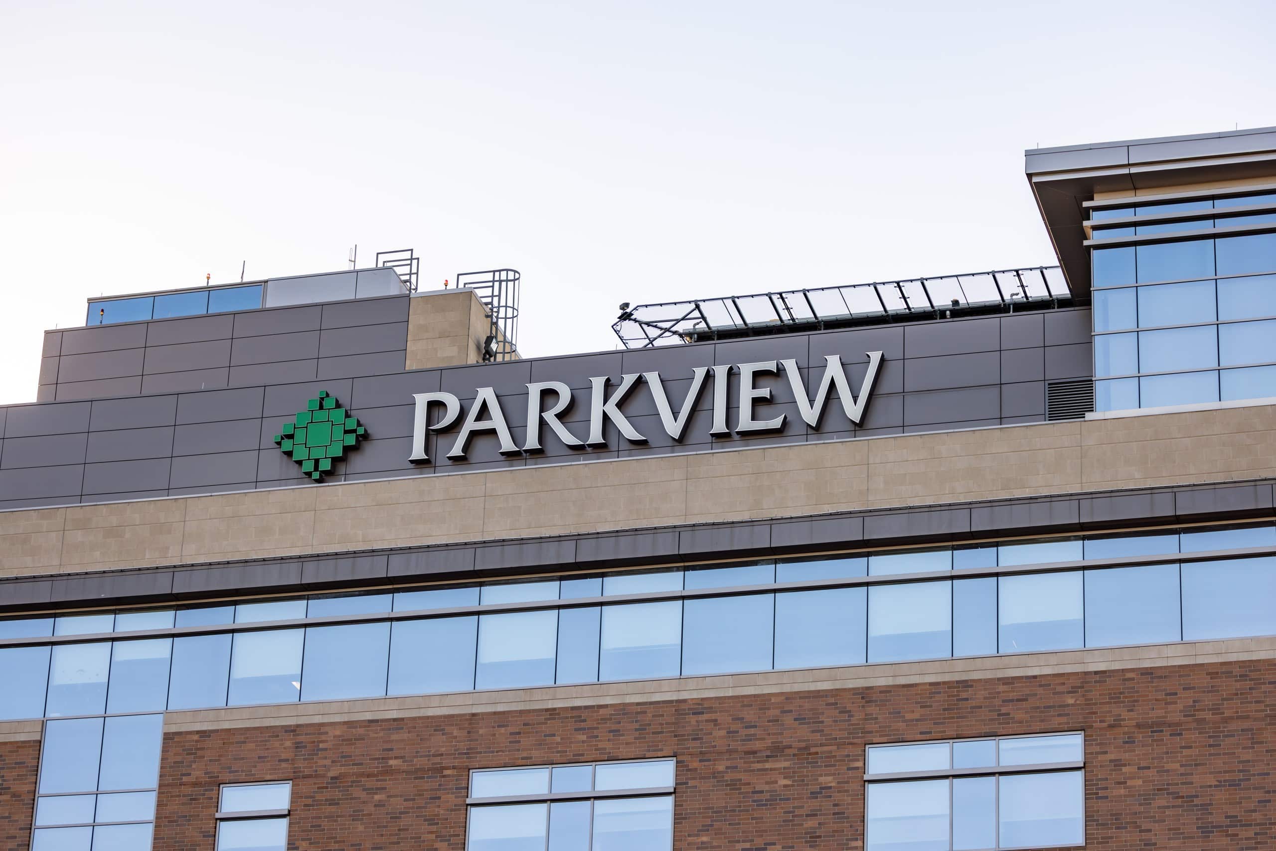 The top of a multistory, grey and brown building with large white letters that read "Parkview."